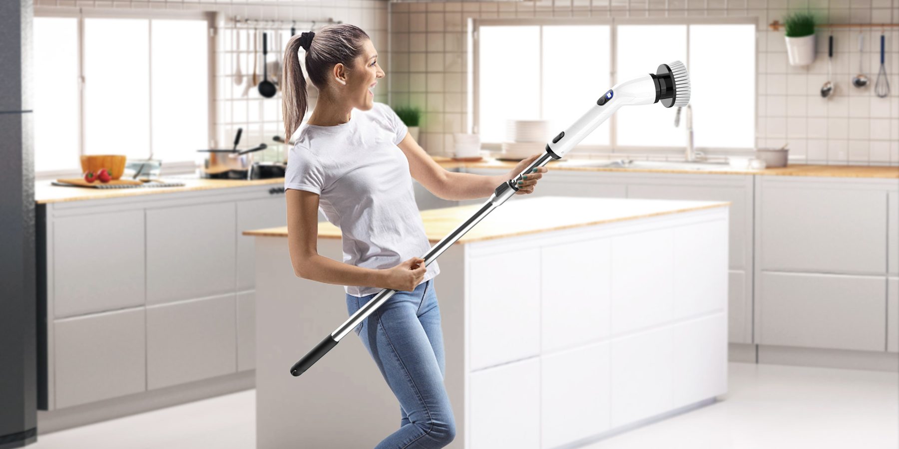 Woman using the TUYU electric scrub brush with extended handle on a high wall